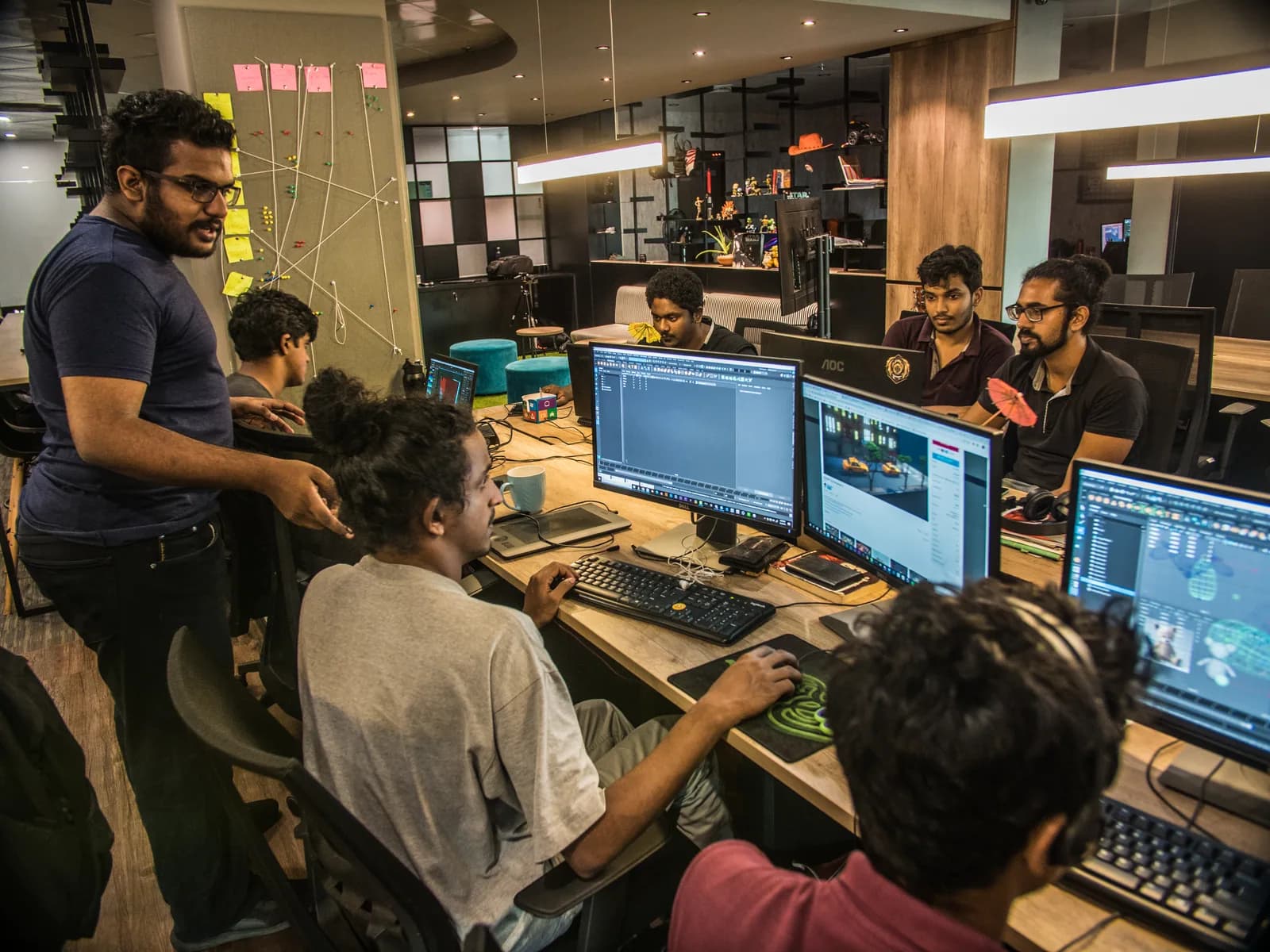 Team members working together at the studio computers