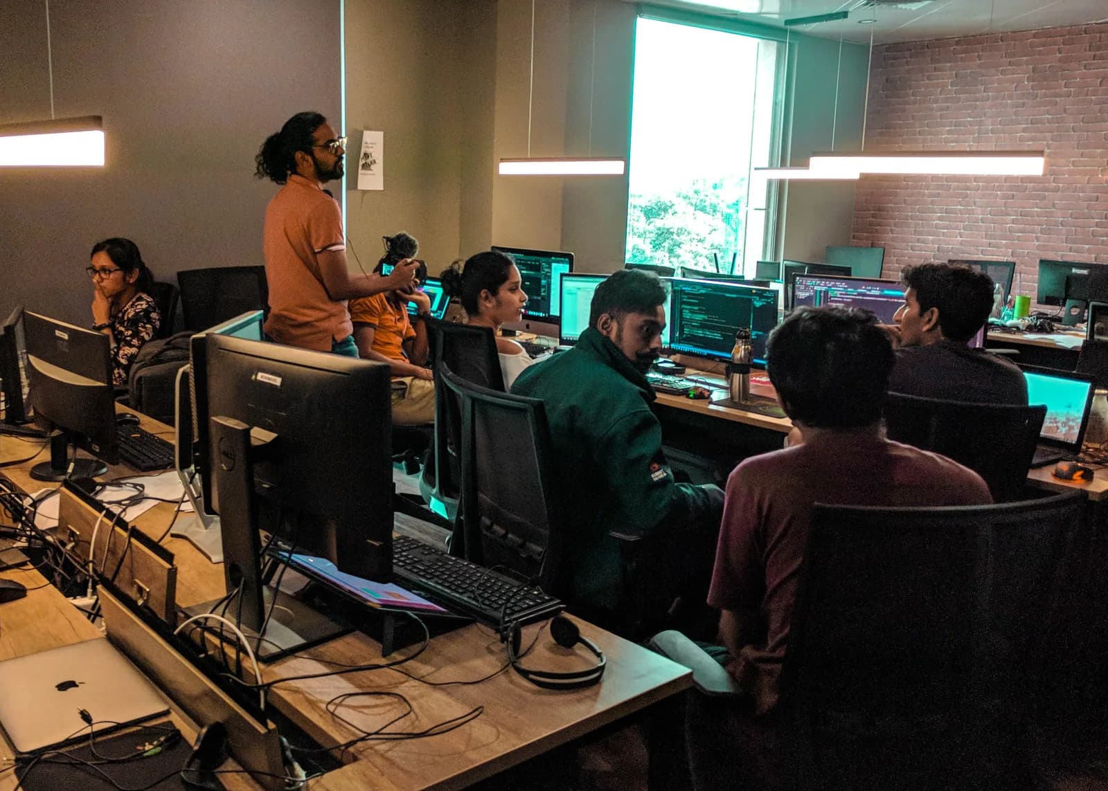 The team collaborating around the studio workstations