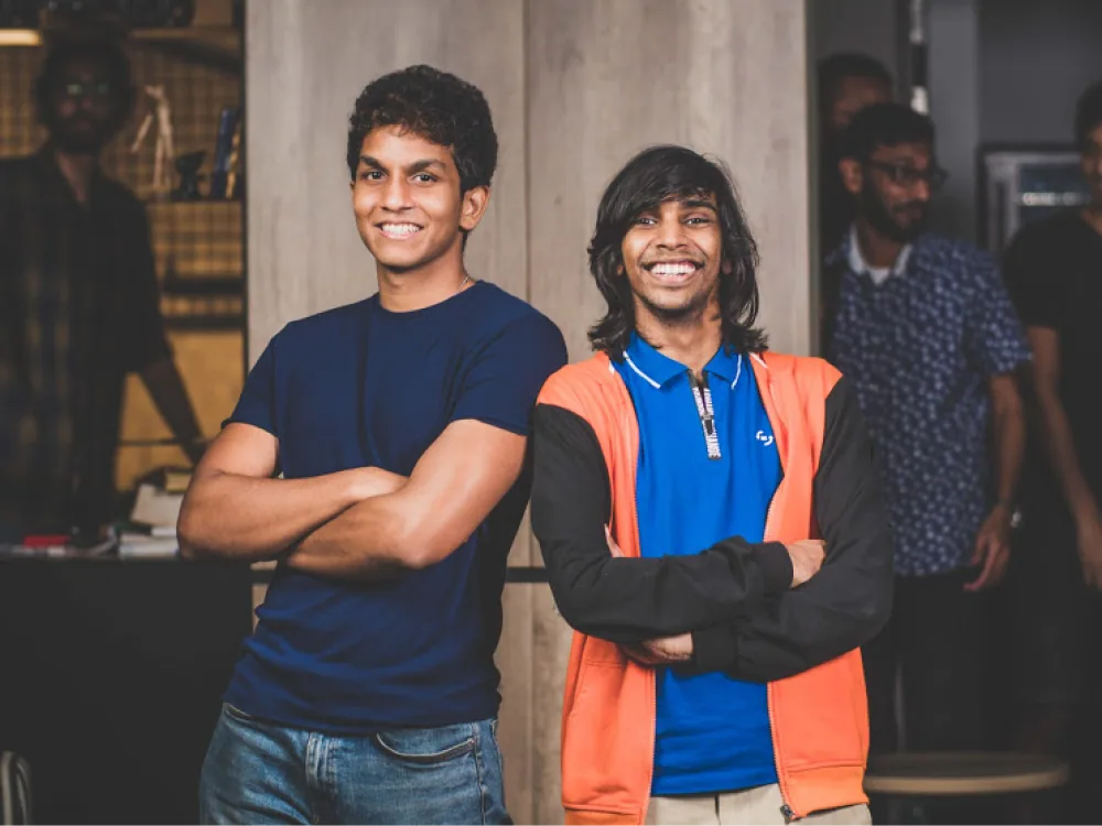 Two team members smiling in the studio