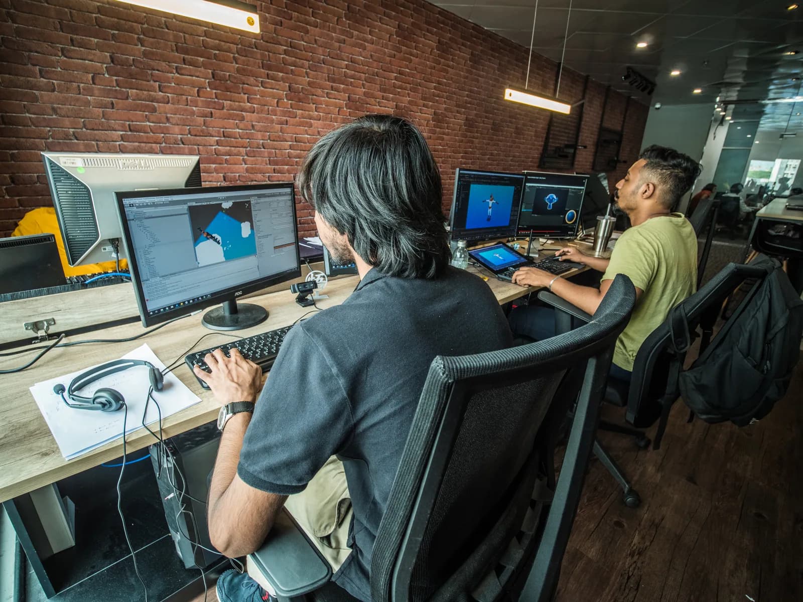 Artists reviewing scenes on their studio screens