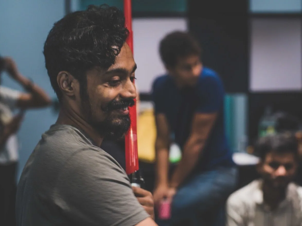 A colleague smiling during a studio gathering