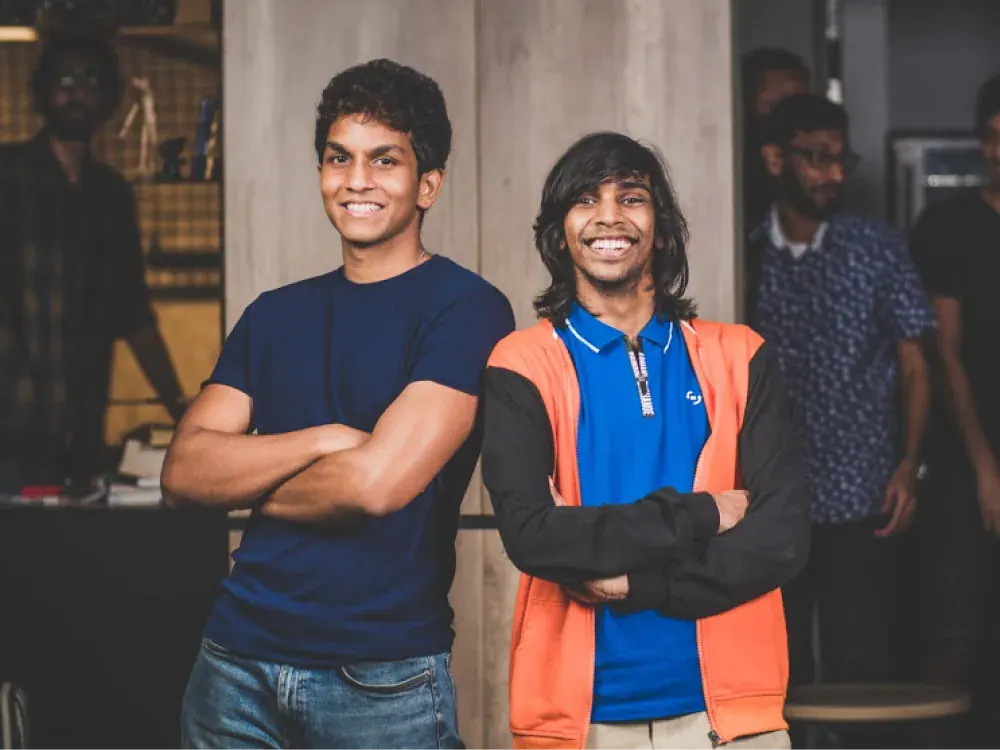 Two team members smiling in the studio